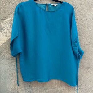 Naked Zebra top. Turquoise. Size Medium. Dolman sleeve. Draw string bottom.
